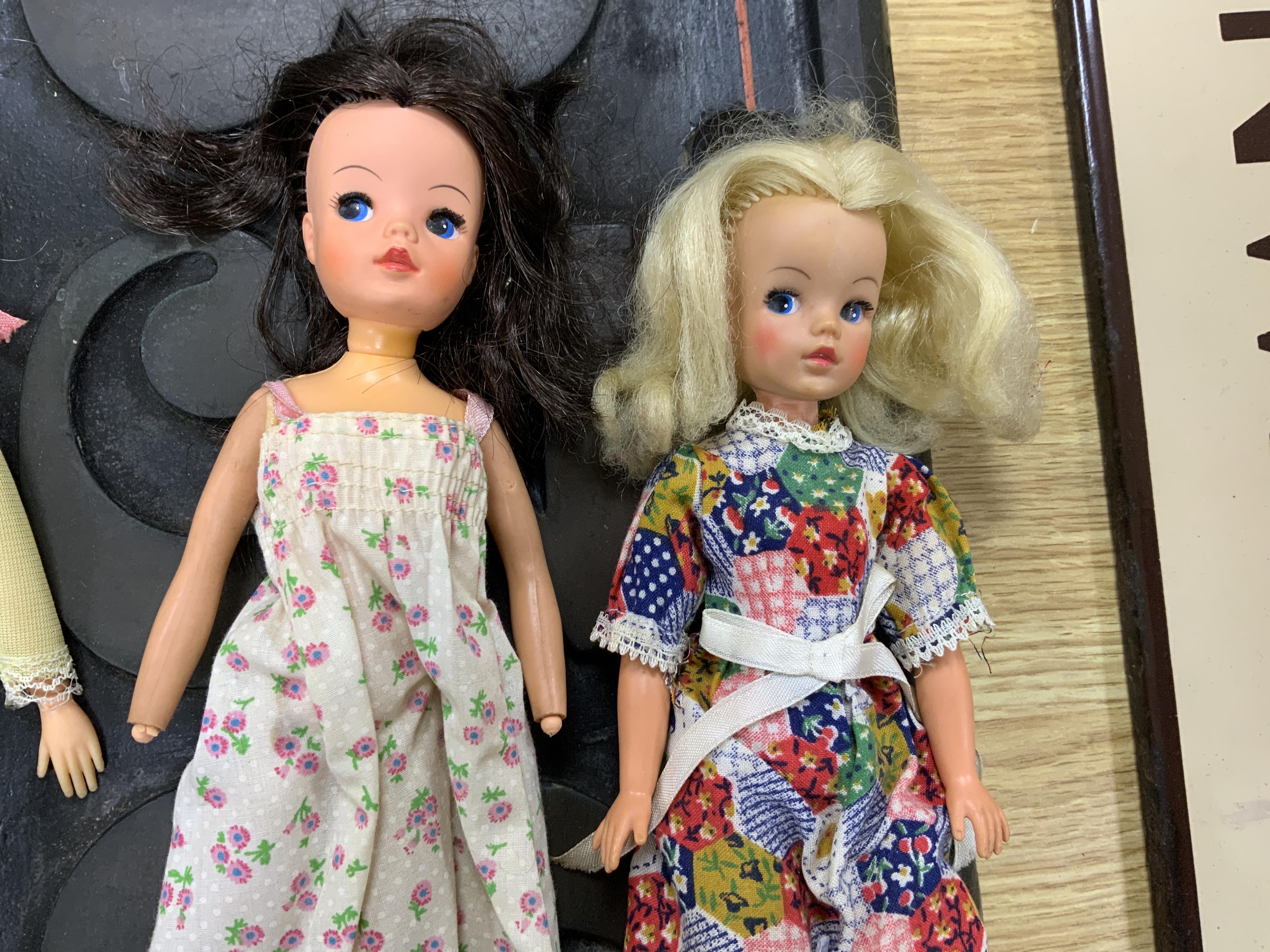 A collection of 1960s-80s Sindy dolls and accessories, including; five dolls, an early plywood and hardboard caravan, a large selection of clothing and accessories, furniture, house fittings, including a shower, wardrobe